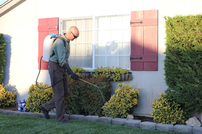 Pest control technician treating a home for termites