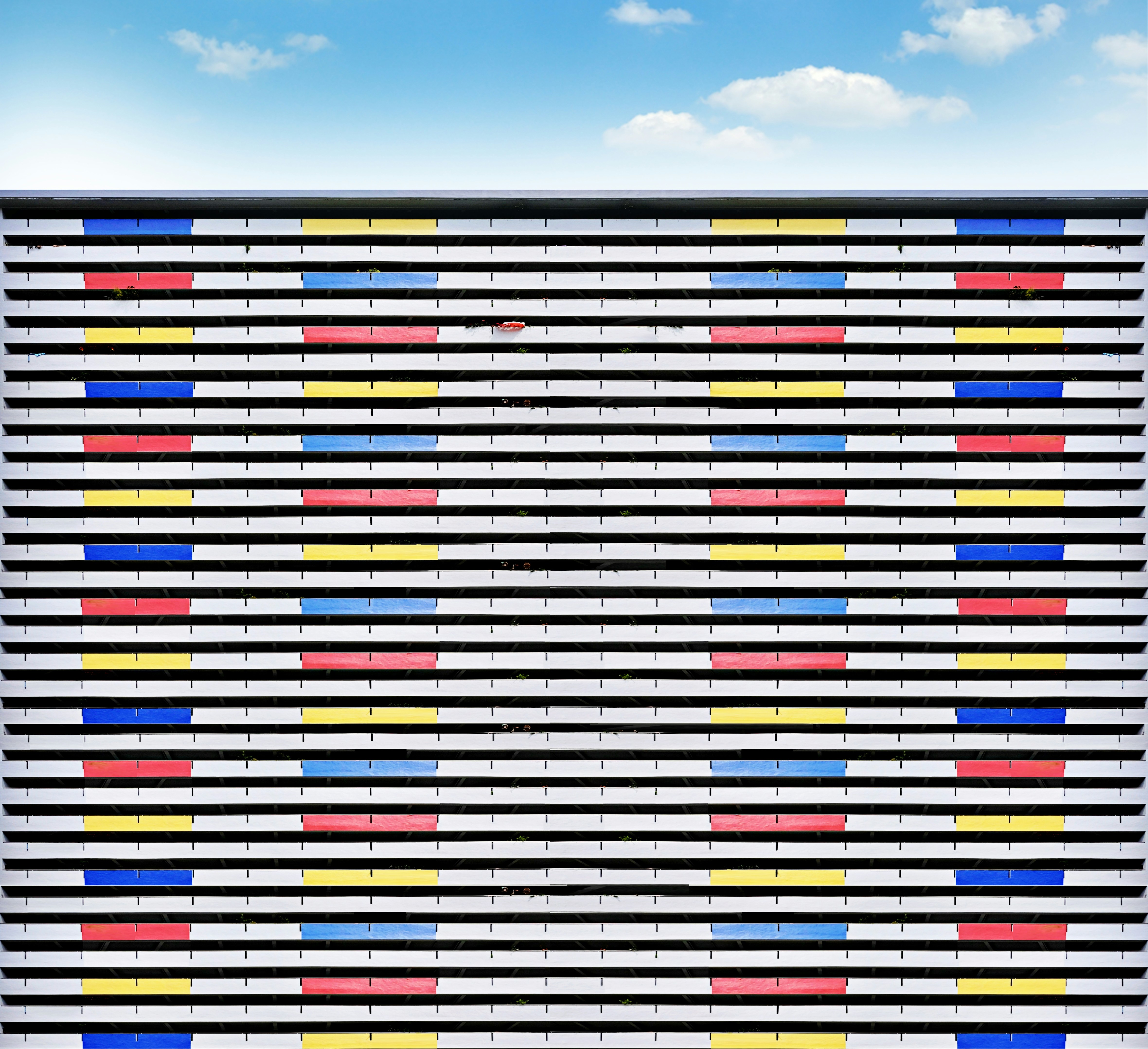 A large wall or panel with multicolored rows and columns that looks like of like a spreadsheet.