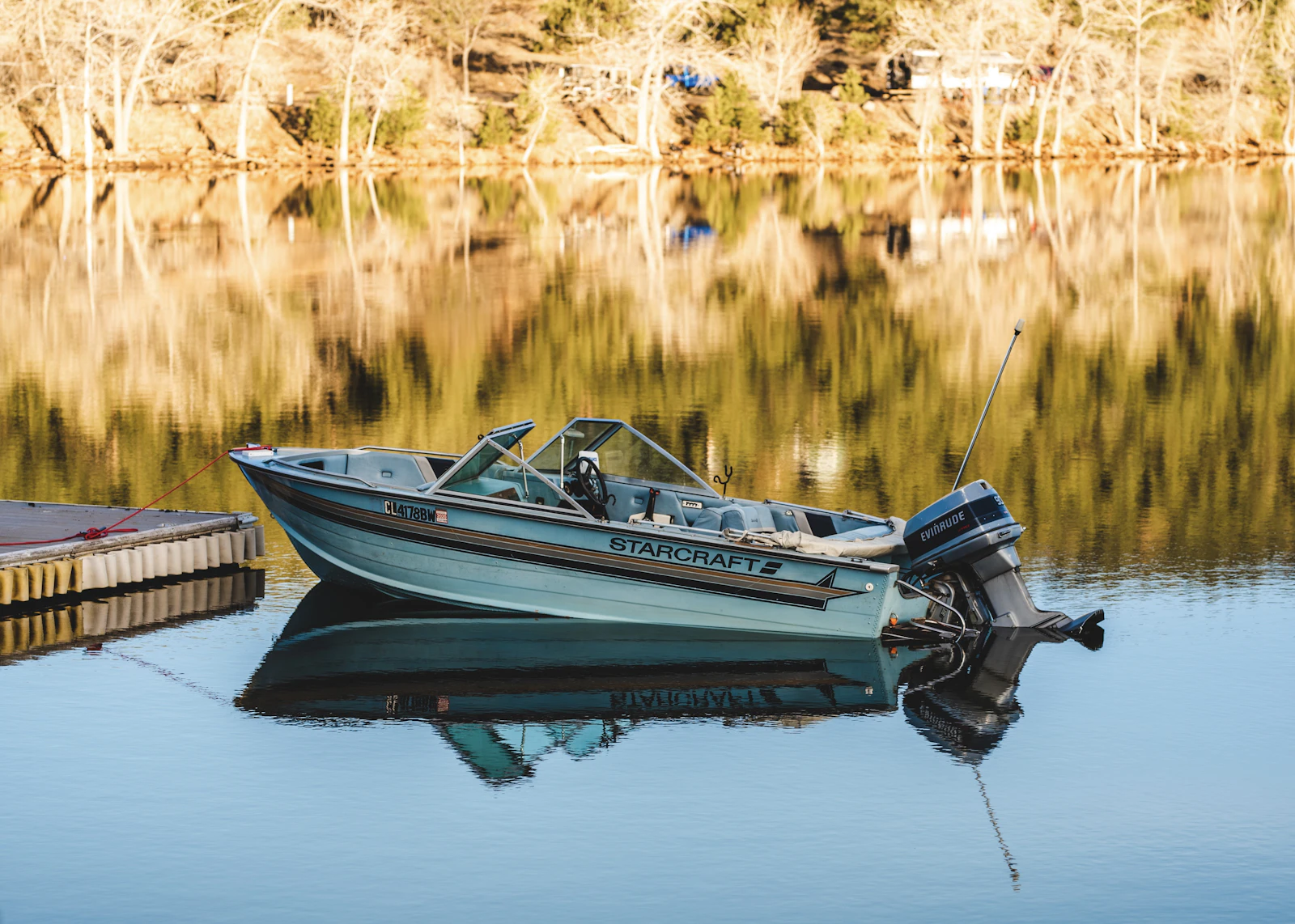 Boat tied alongside a wooden dock