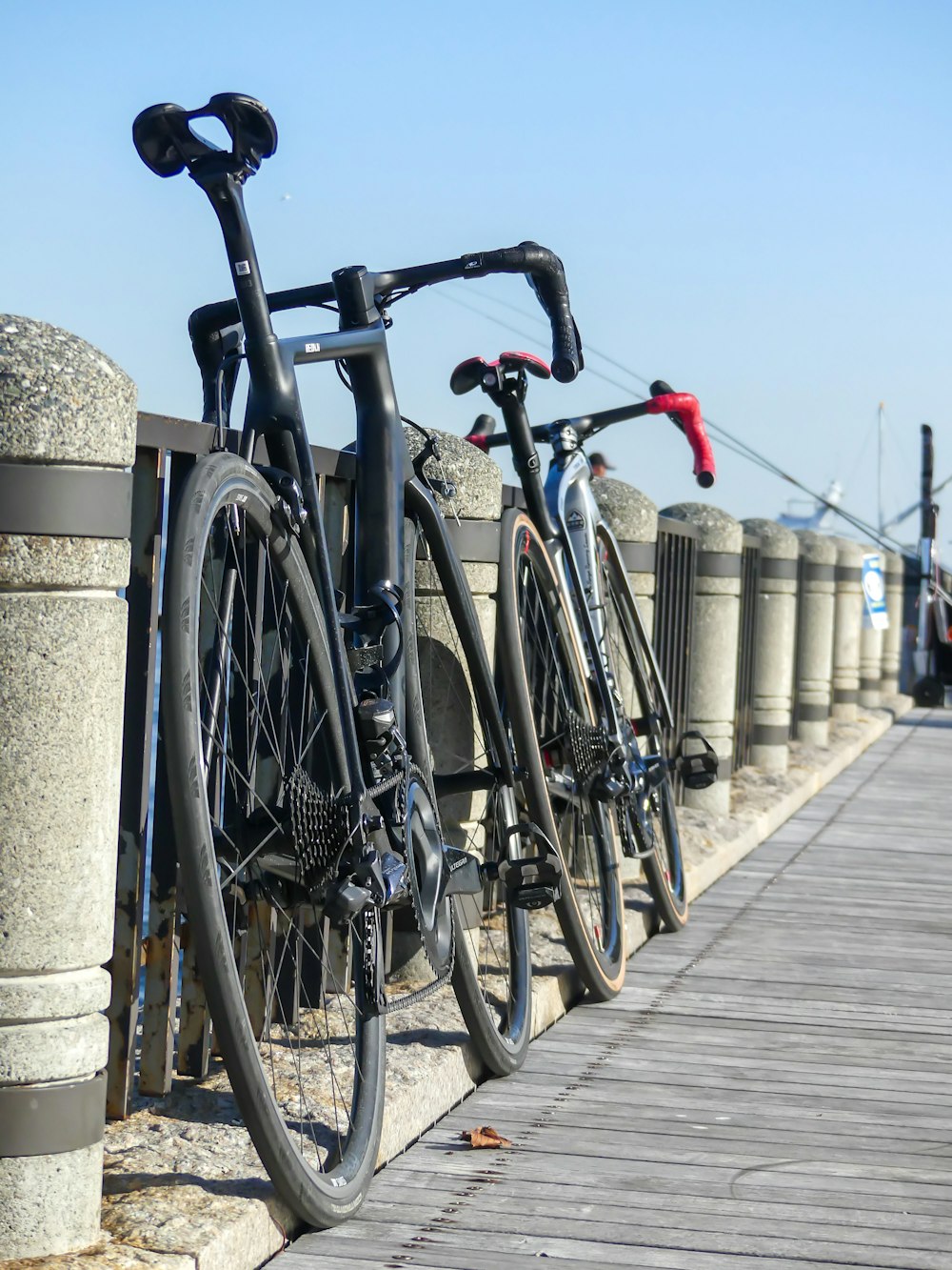 two bikes parked next to each other on a bridge