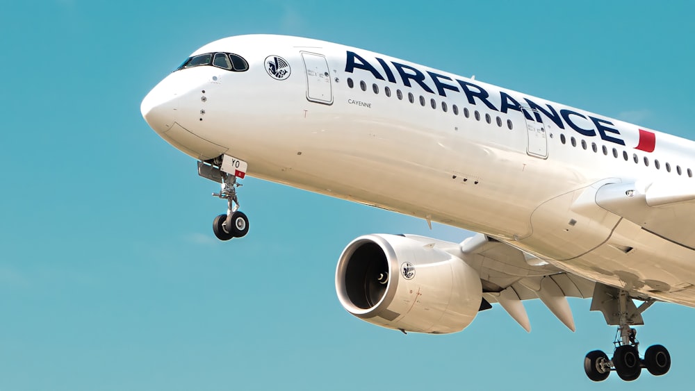 a large airfrance jet flying through a blue sky