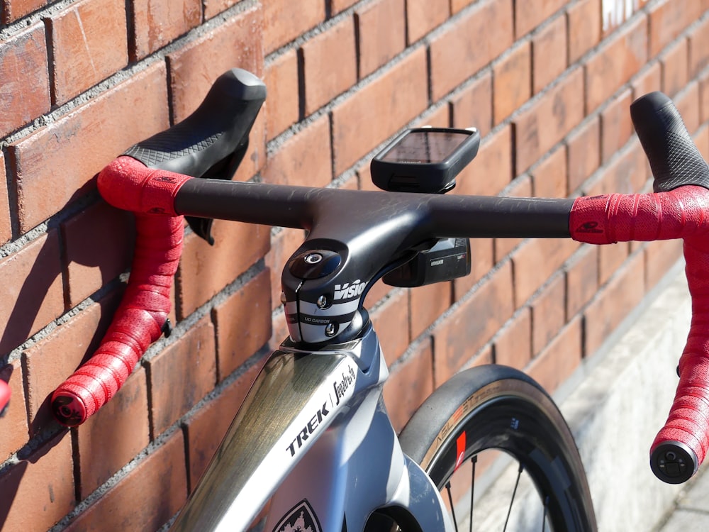 a bike parked next to a brick wall