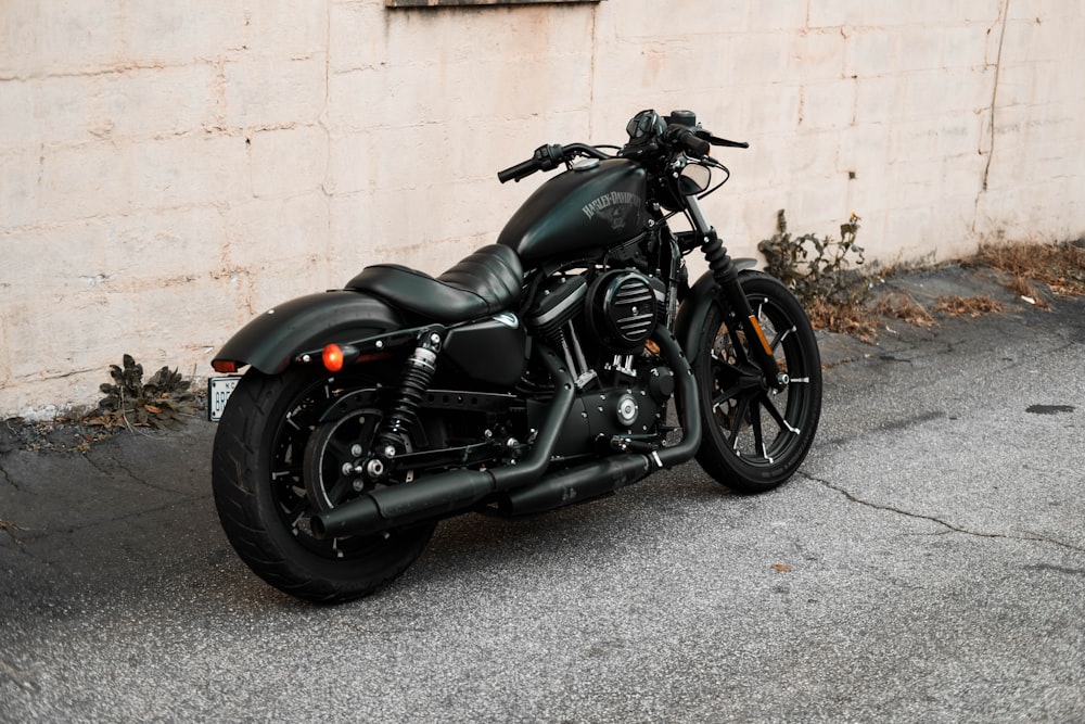 a black motorcycle parked in front of a building