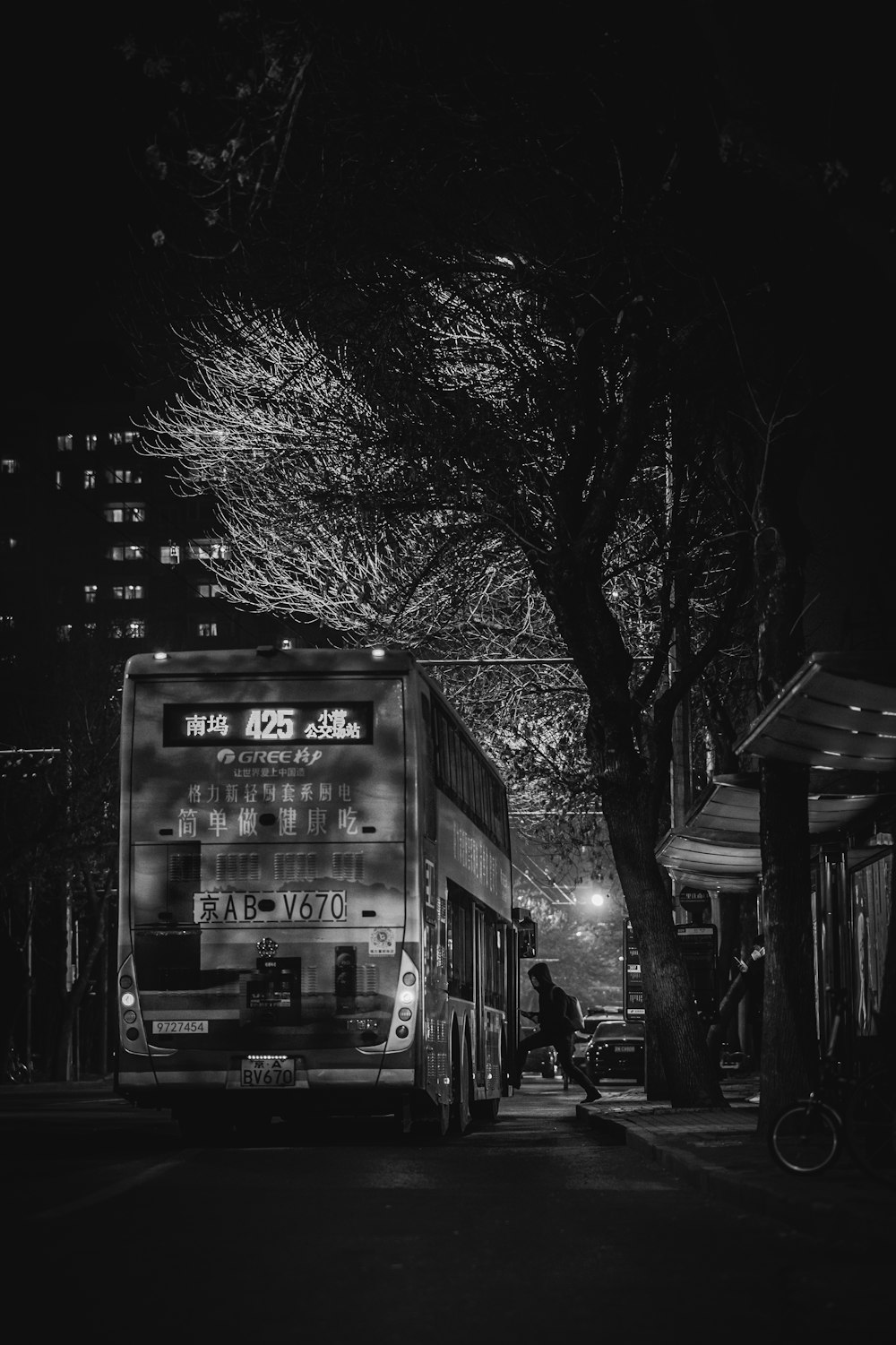 a black and white photo of a bus at night