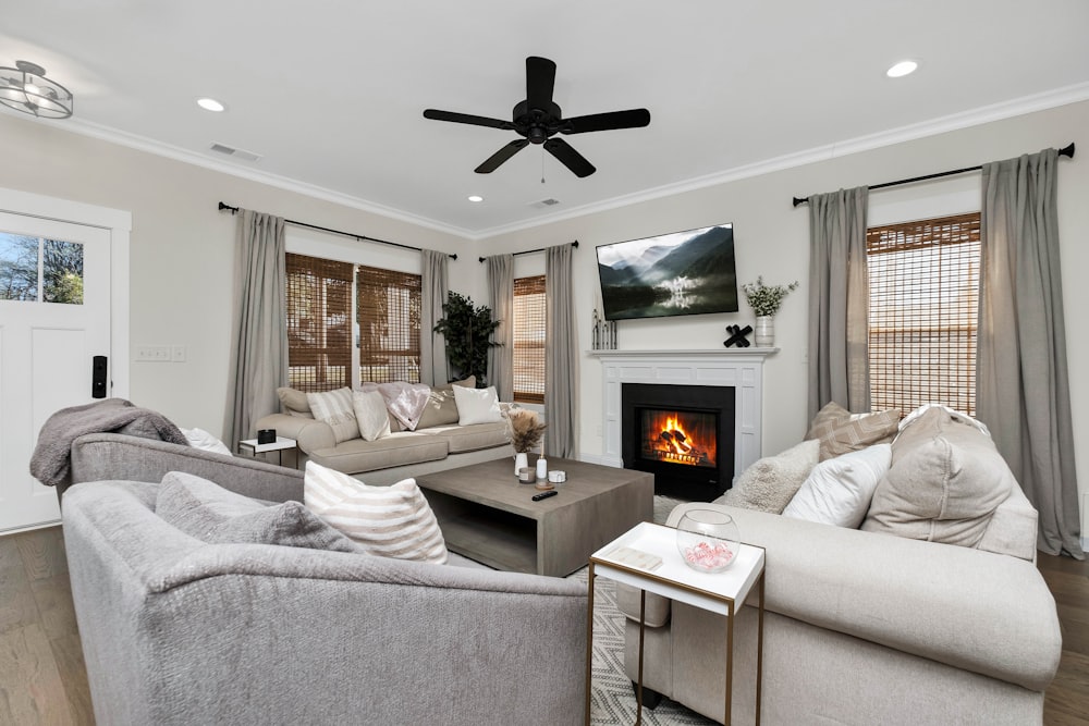 a living room filled with furniture and a fire place