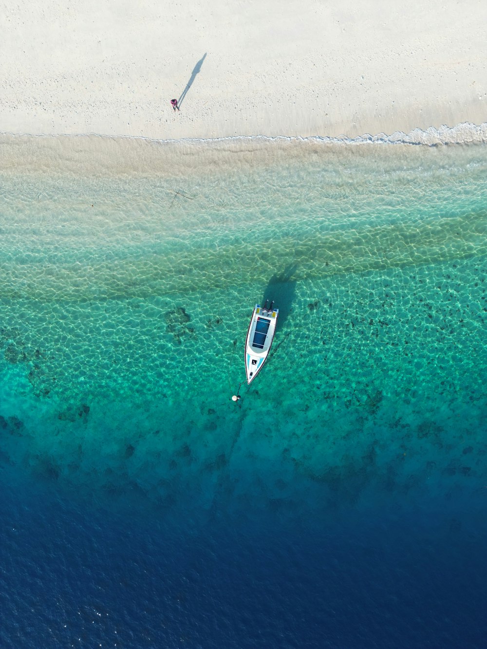 an aerial view of a boat in the water