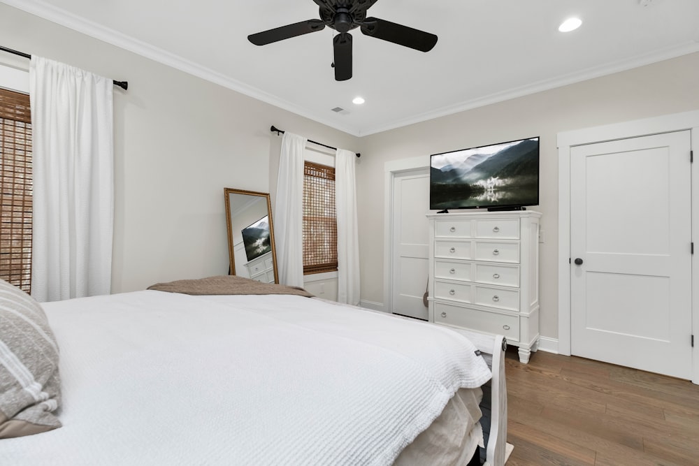 a bedroom with a large bed and a flat screen tv