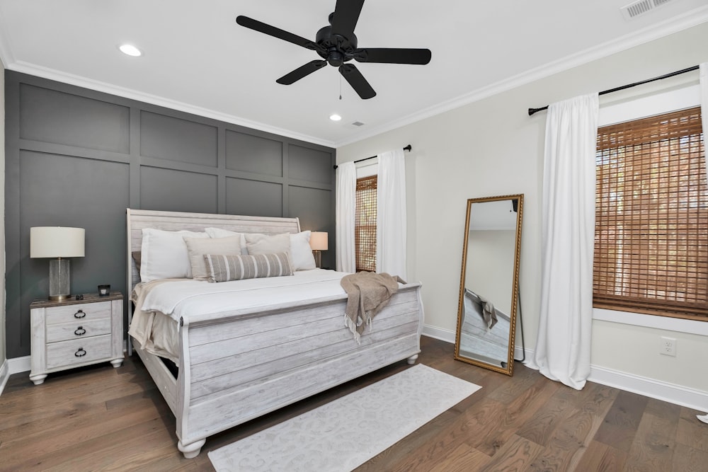 a bedroom with a large bed and a ceiling fan