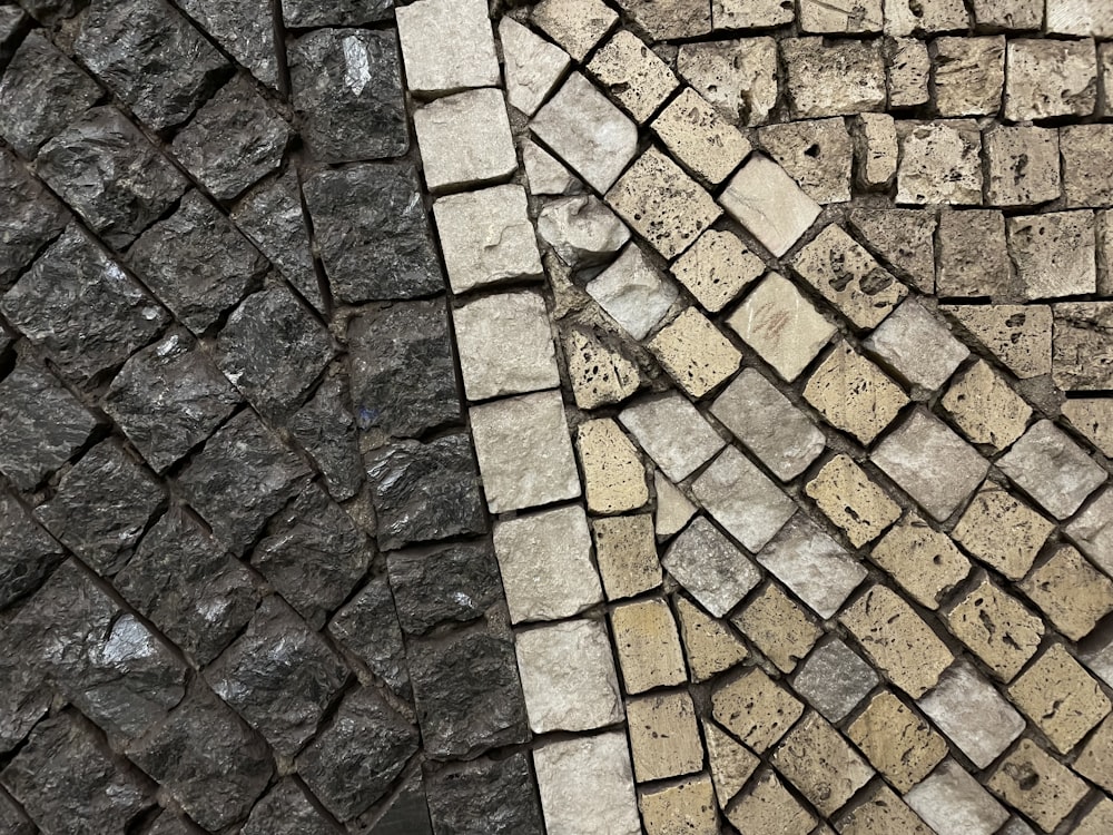 a close up of a brick wall and a stone floor