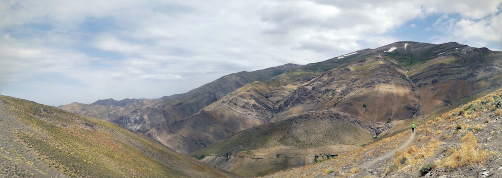 a view of a mountain range from the top of a hill