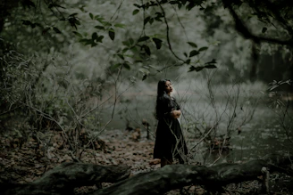 Woman enjoying a peaceful moment outdoors in a natural green setting, symbolizing health and well-being.