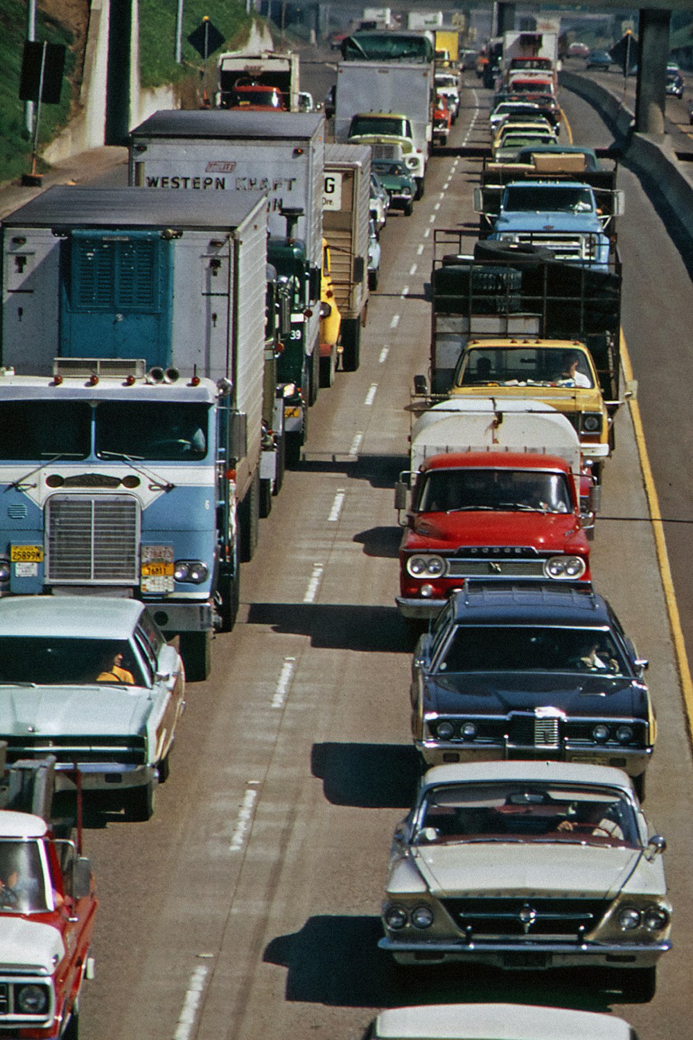 a street filled with lots of traffic next to a bridge