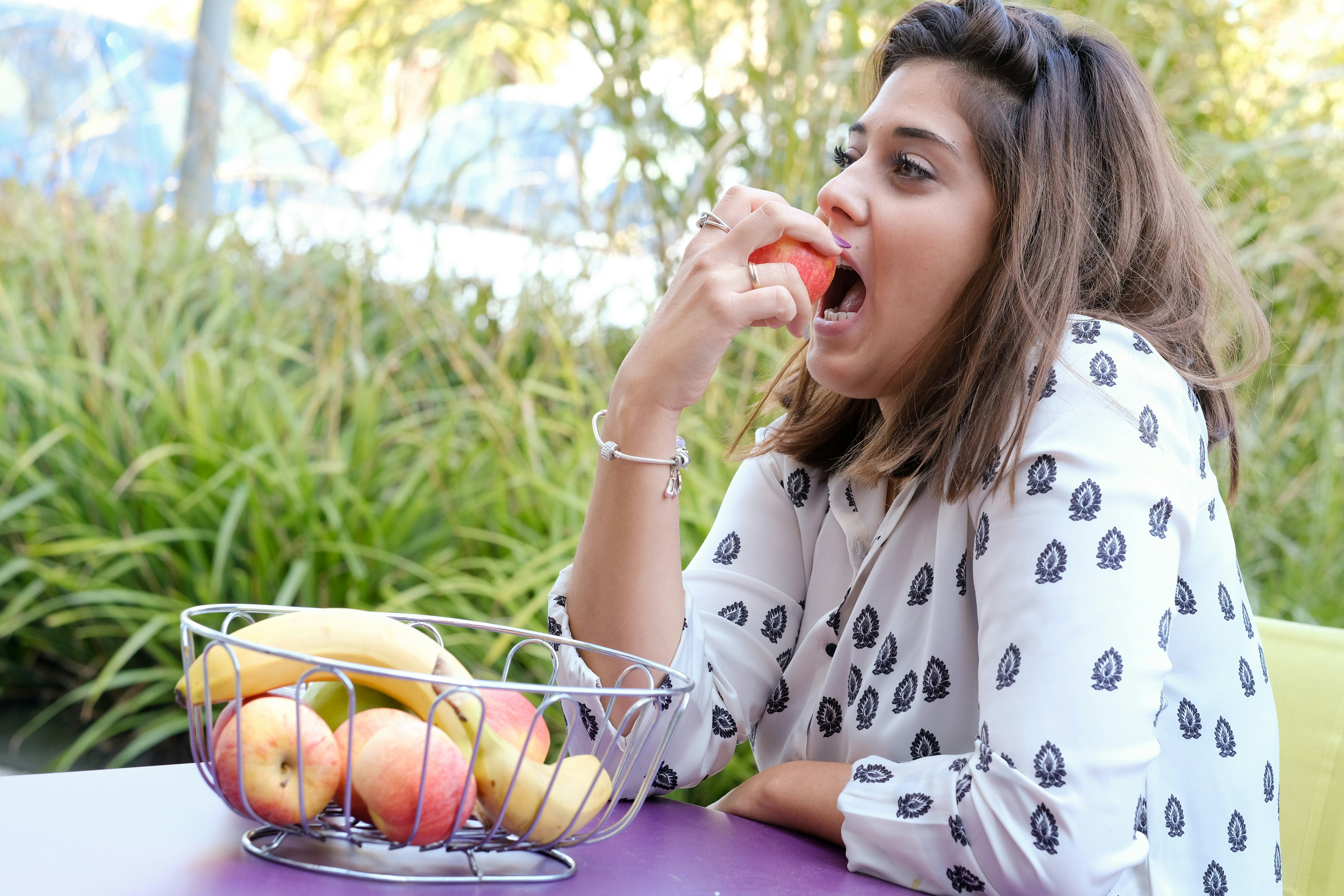 Person enjoying a healthy snack, demonstrating careful eating habits for bonded teeth - does dental bonding hurt