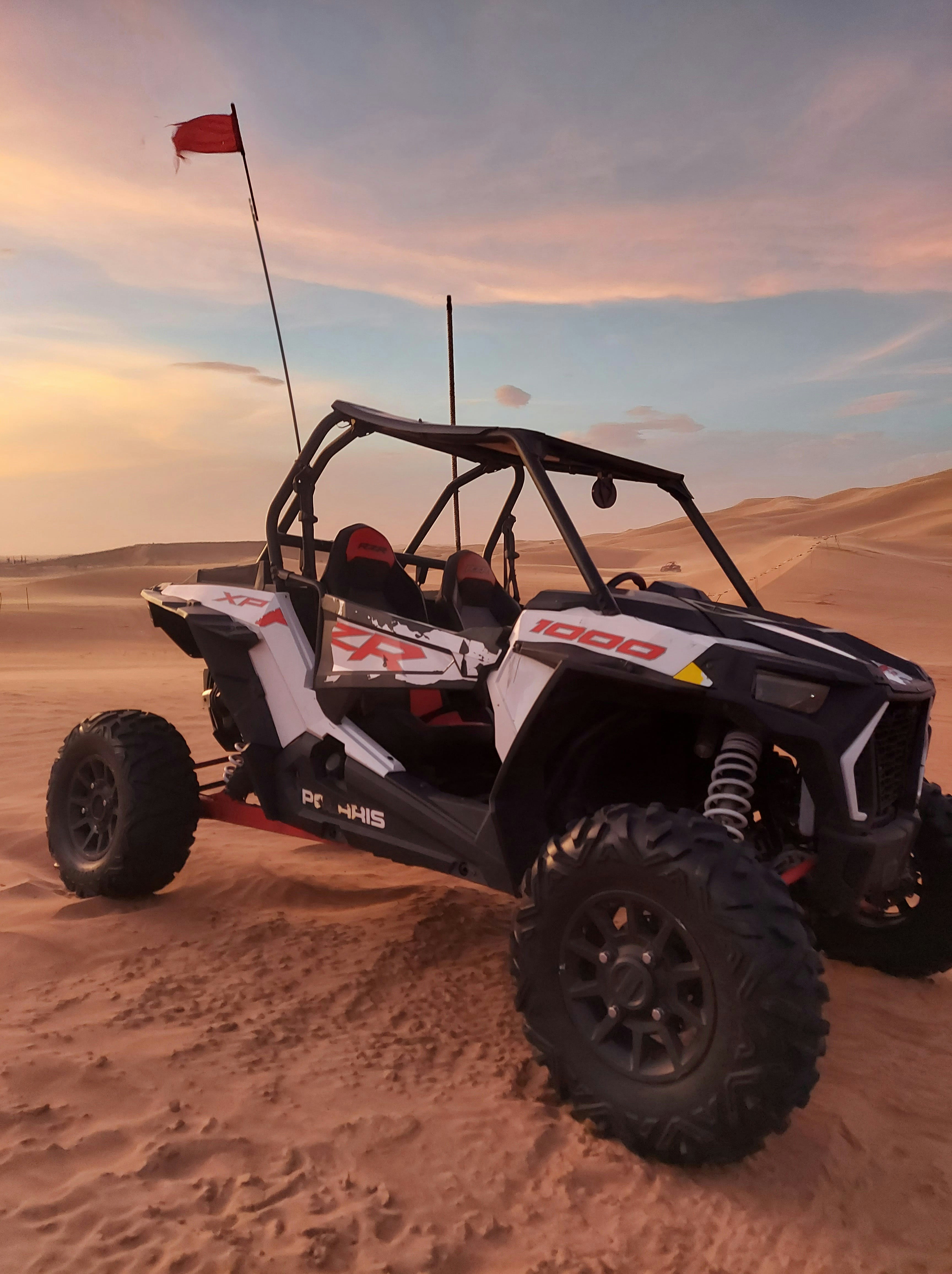 Happy tourists on UTV adventure in bright outdoor setting