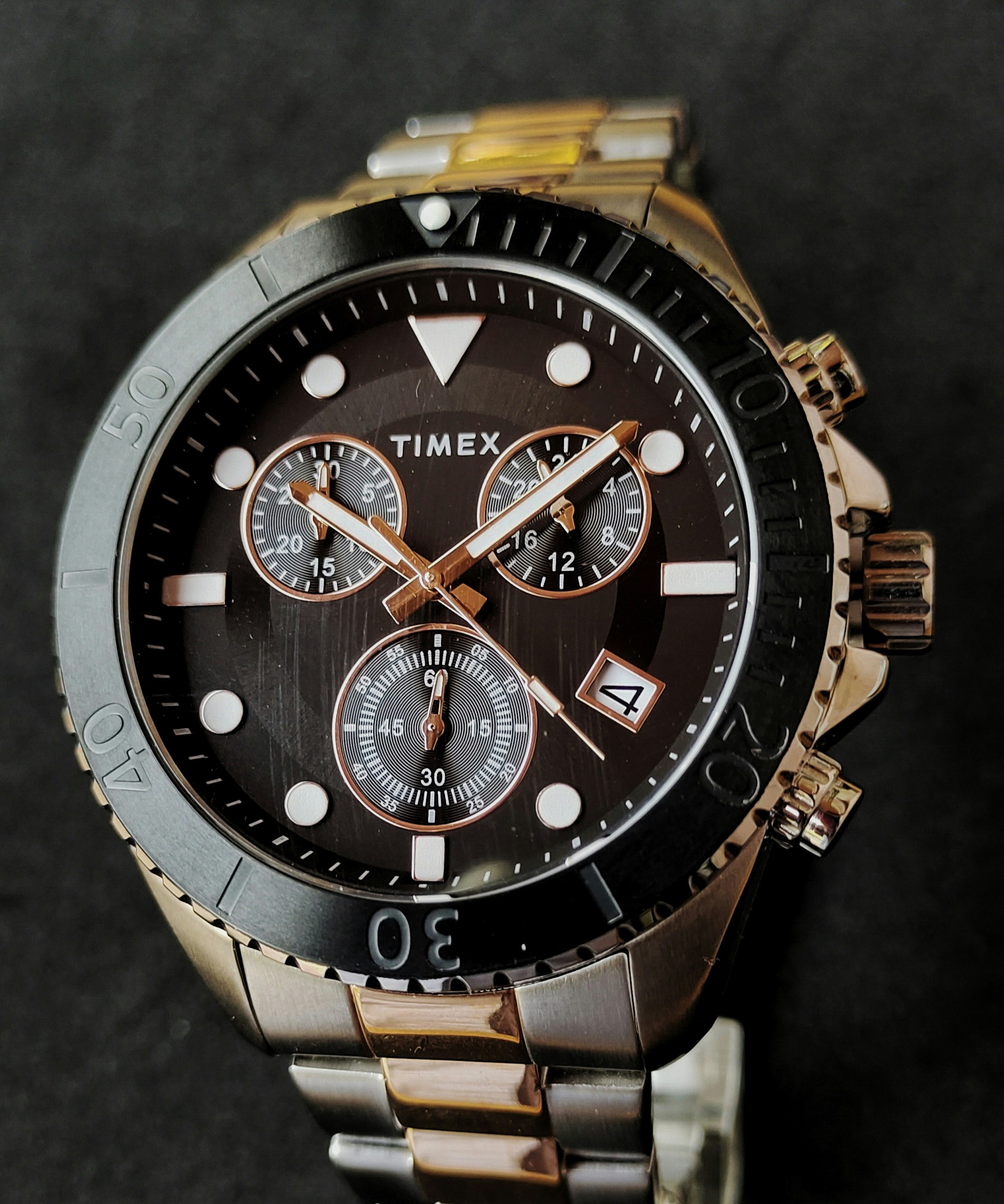 a close up of a watch on a black surface