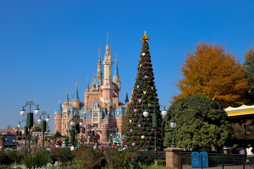 a christmas tree in front of a castle