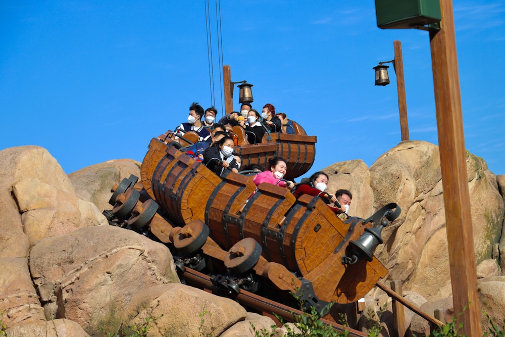 a group of people riding on top of a wooden pirate ship