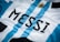 A close-up of a sports jersey featuring blue and white vertical stripes and the name 'MESSI' printed in bold black letters. A golden sun emblem is visible near the top.