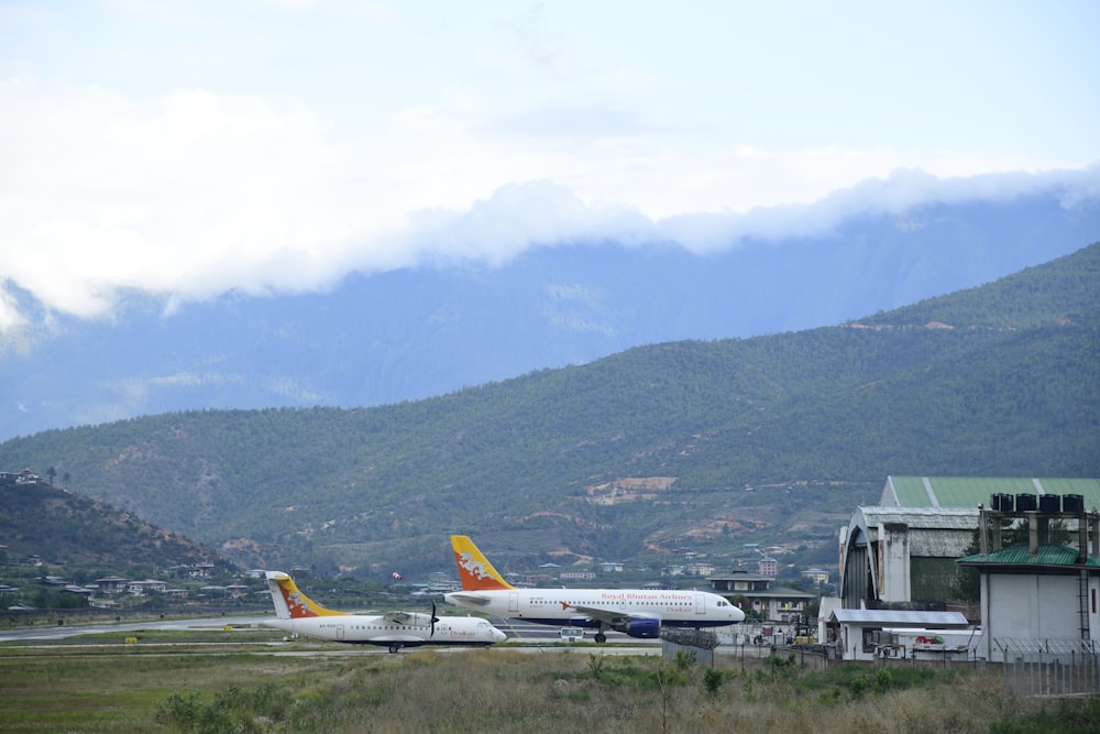 a couple of planes that are on a runway