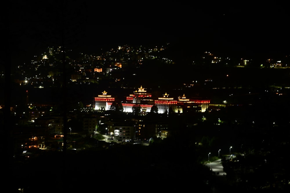 a view of a city at night from the top of a hill