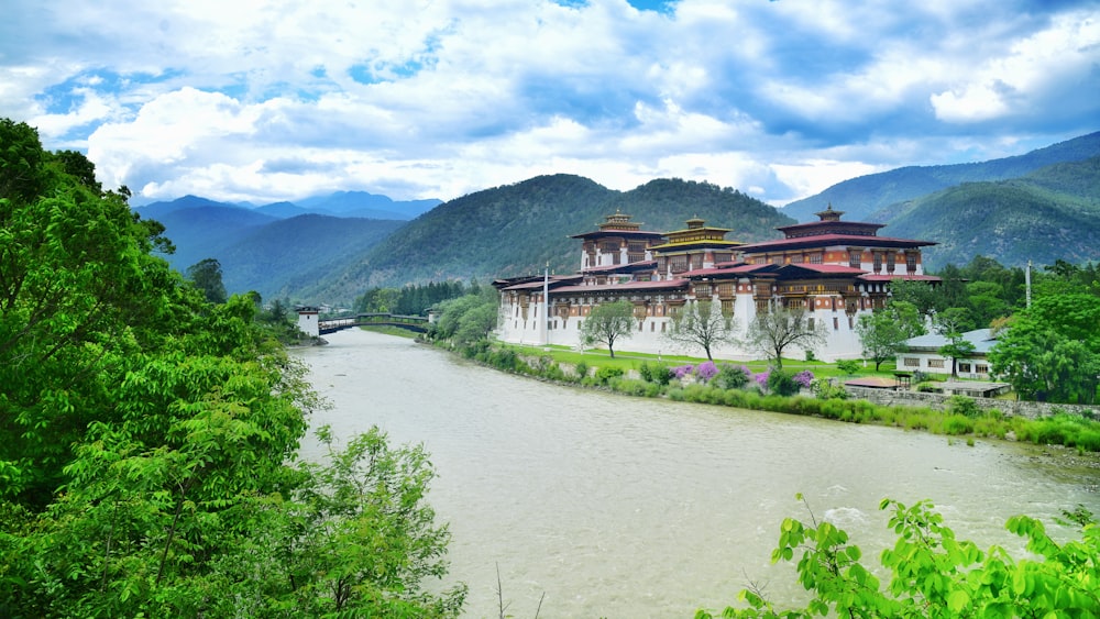 a large building sitting on the side of a river