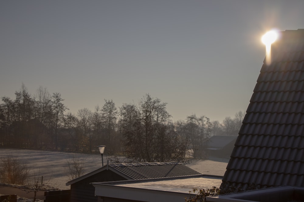 the sun shines brightly on the roof of a house