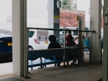 Welcoming medical agent greeting a patient at a busy Chinese airport terminal