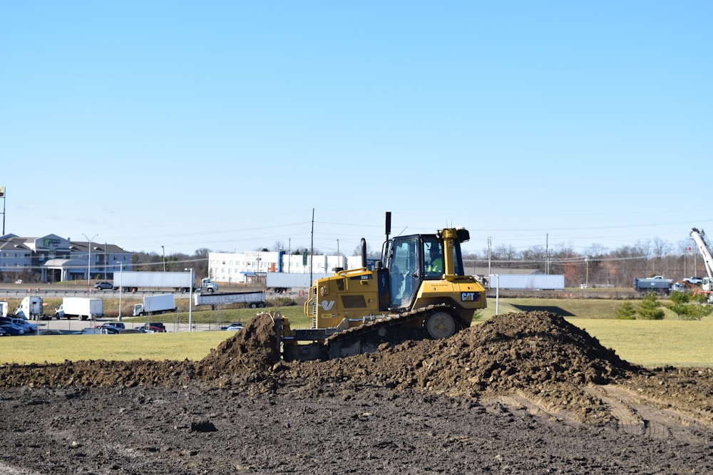 a bulldozer digging through a pile of dirt