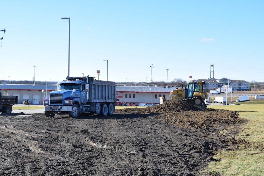 a dump truck driving down a dirt road