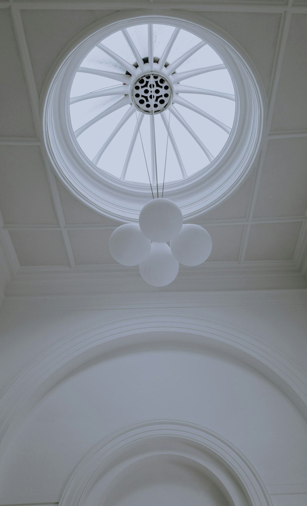 a ceiling with a circular window and a light fixture