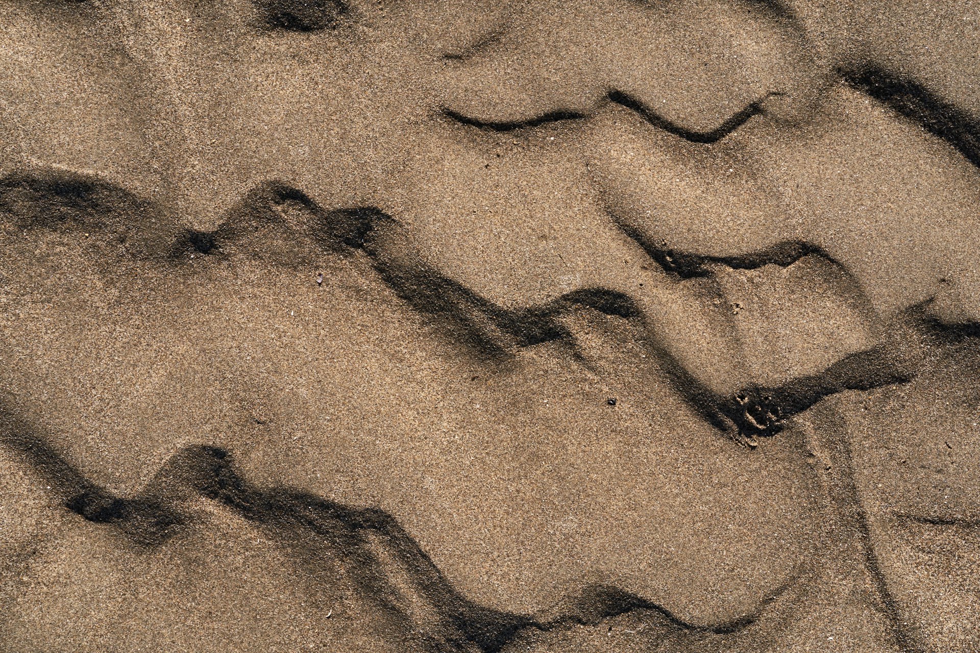 a close up of sand and water on a beach