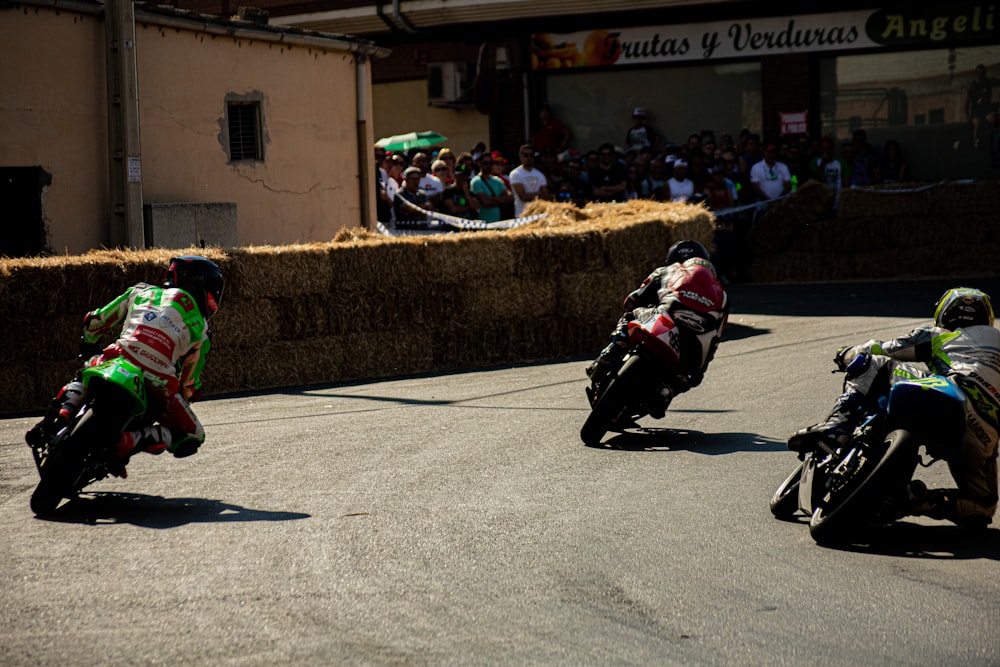 a group of motorcyclists racing down a race track