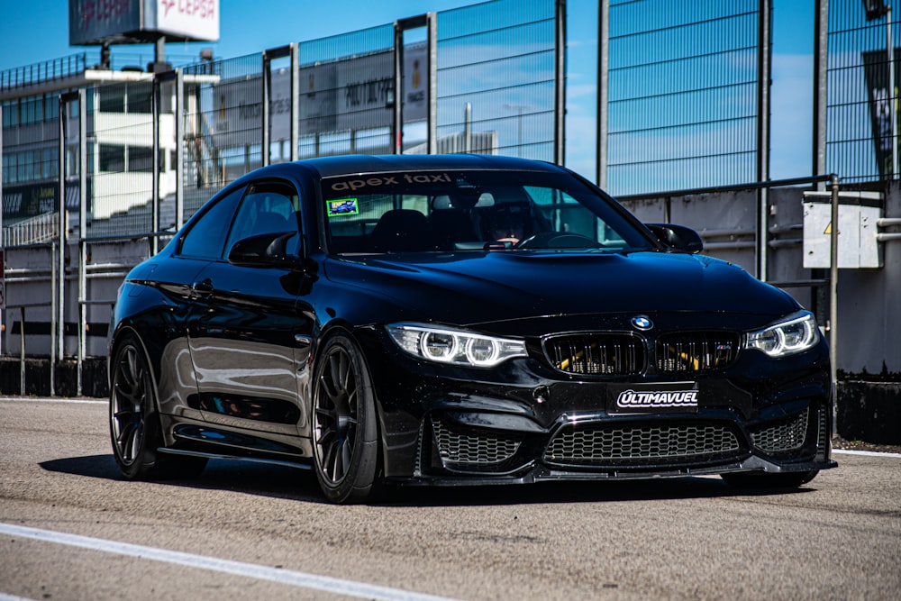 a black car parked on the side of the road