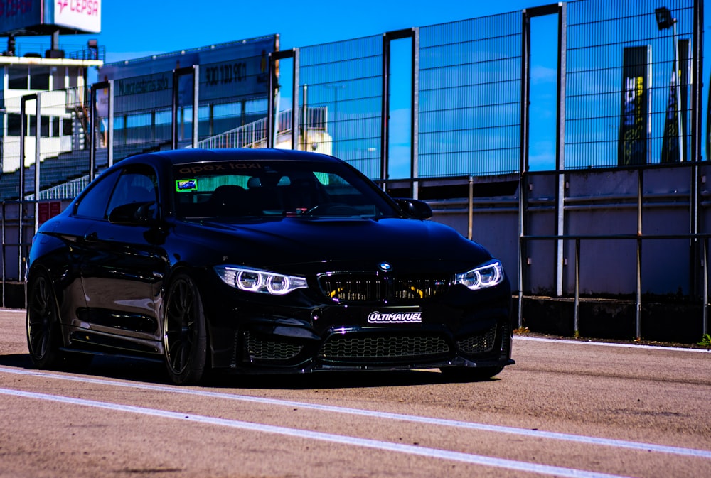 a black car parked on the side of the road