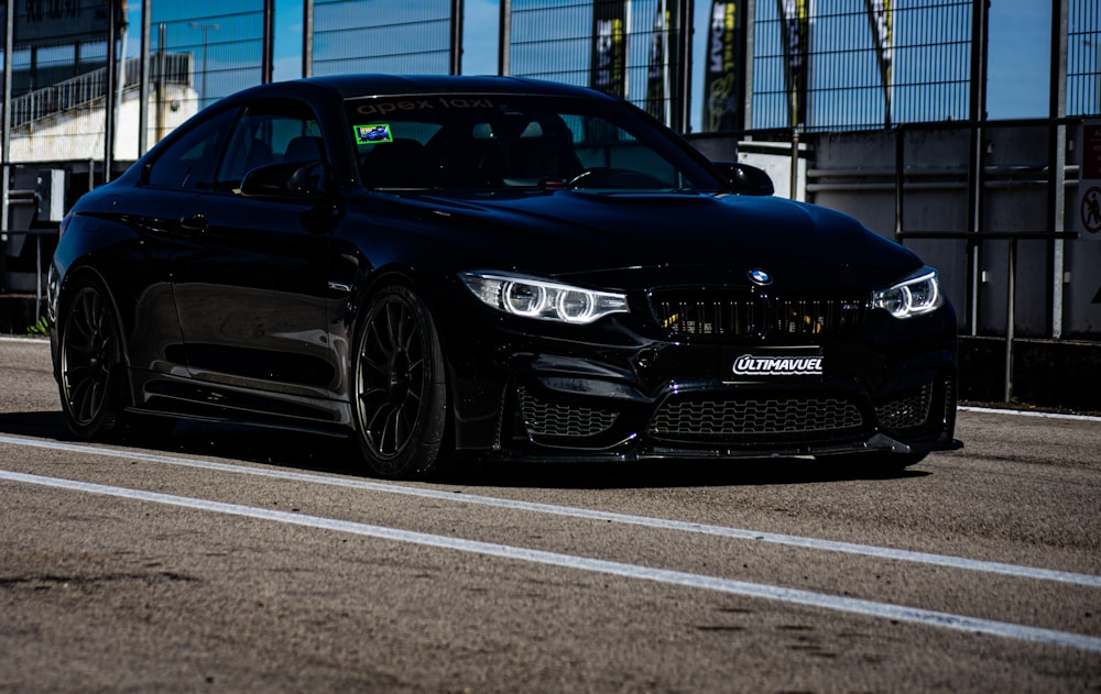 a black car parked on the side of the road