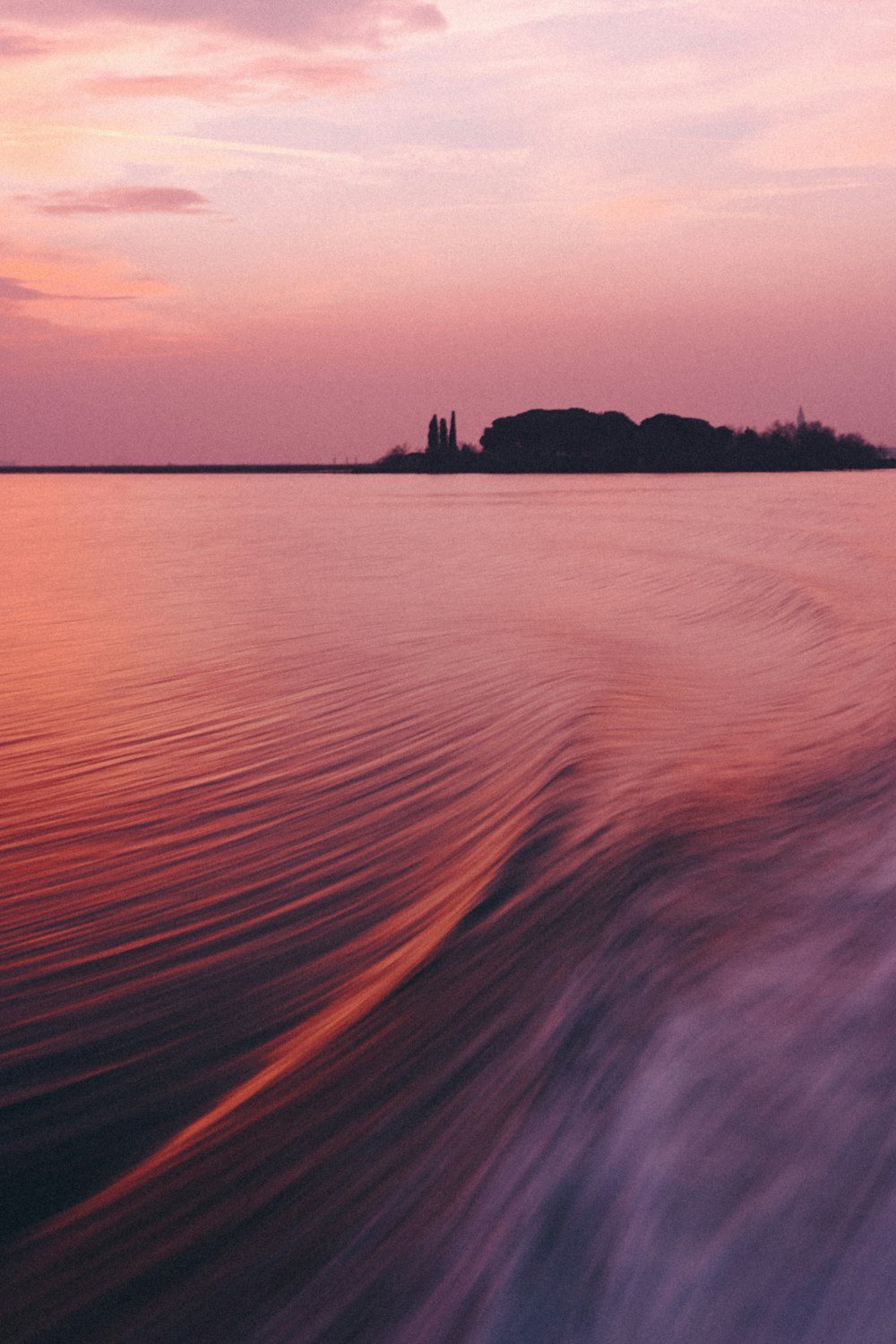 a body of water with a small island in the distance