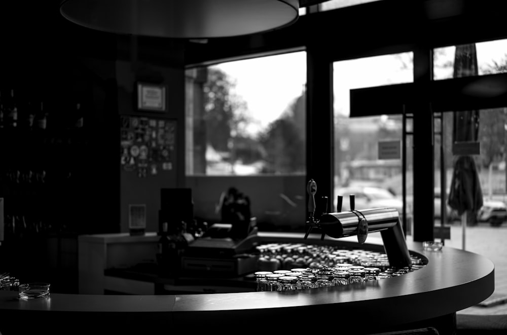 a black and white photo of a bar in a restaurant