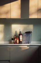 A cozy kitchen counter with various Bumbu Bamboe spice jars and a contact form on a laptop screen.