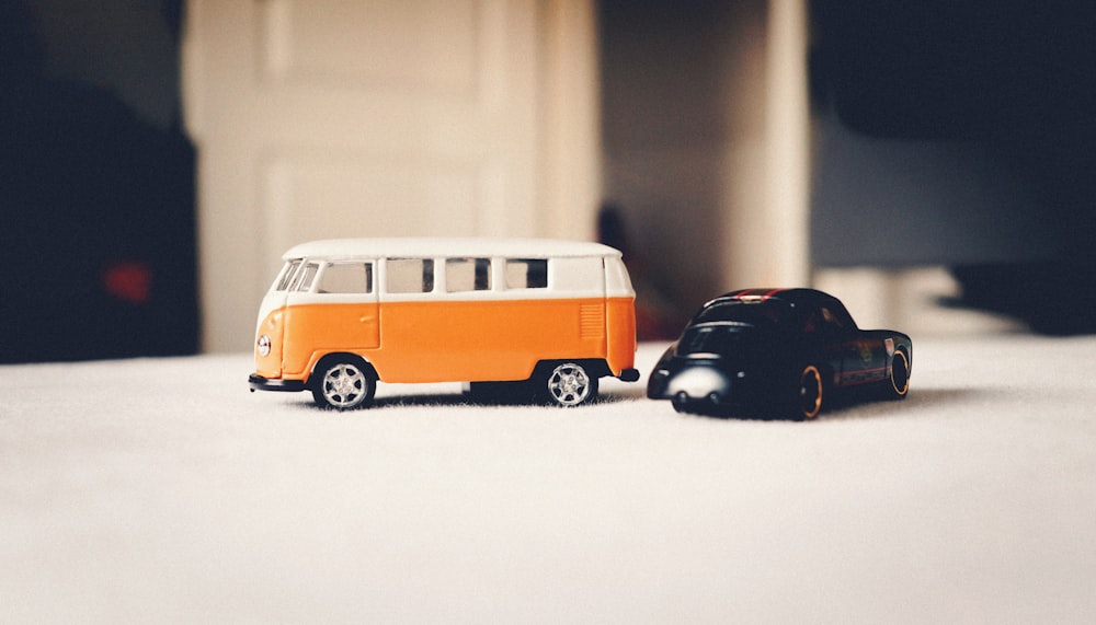 a toy van and a toy car on a table