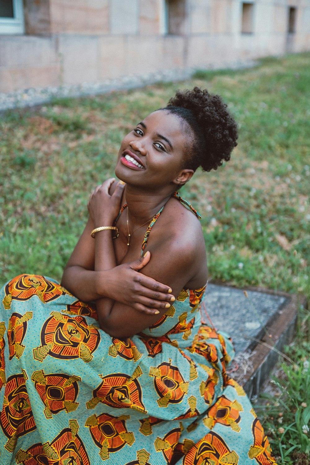 a woman sitting on the ground in a dress