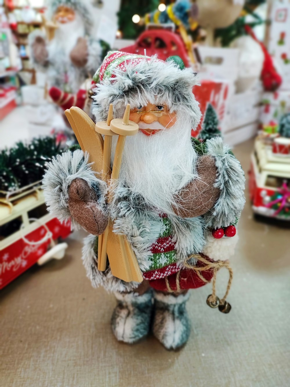 a santa clause figurine holding a wooden sled