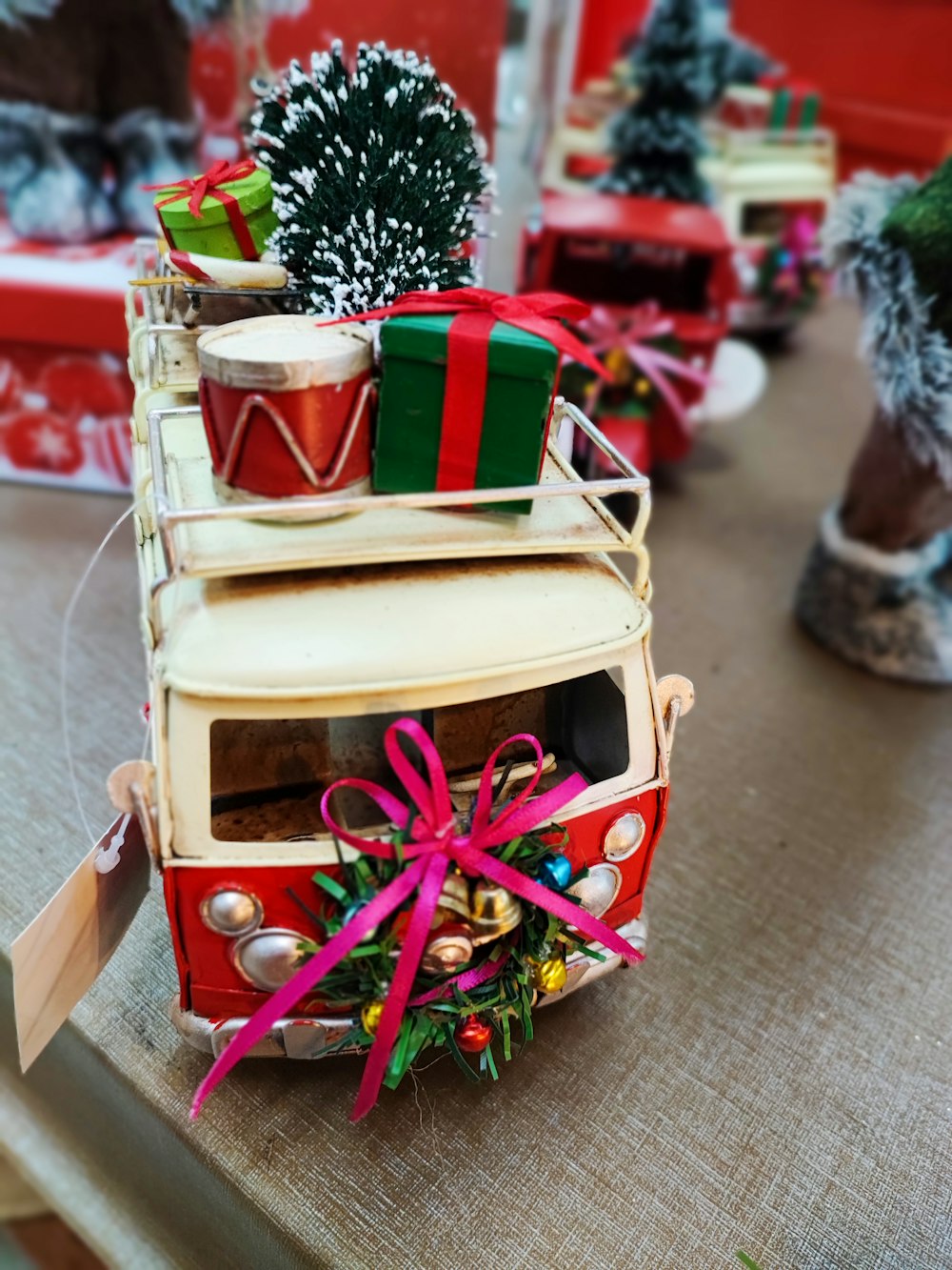 a toy bus with presents on top of it