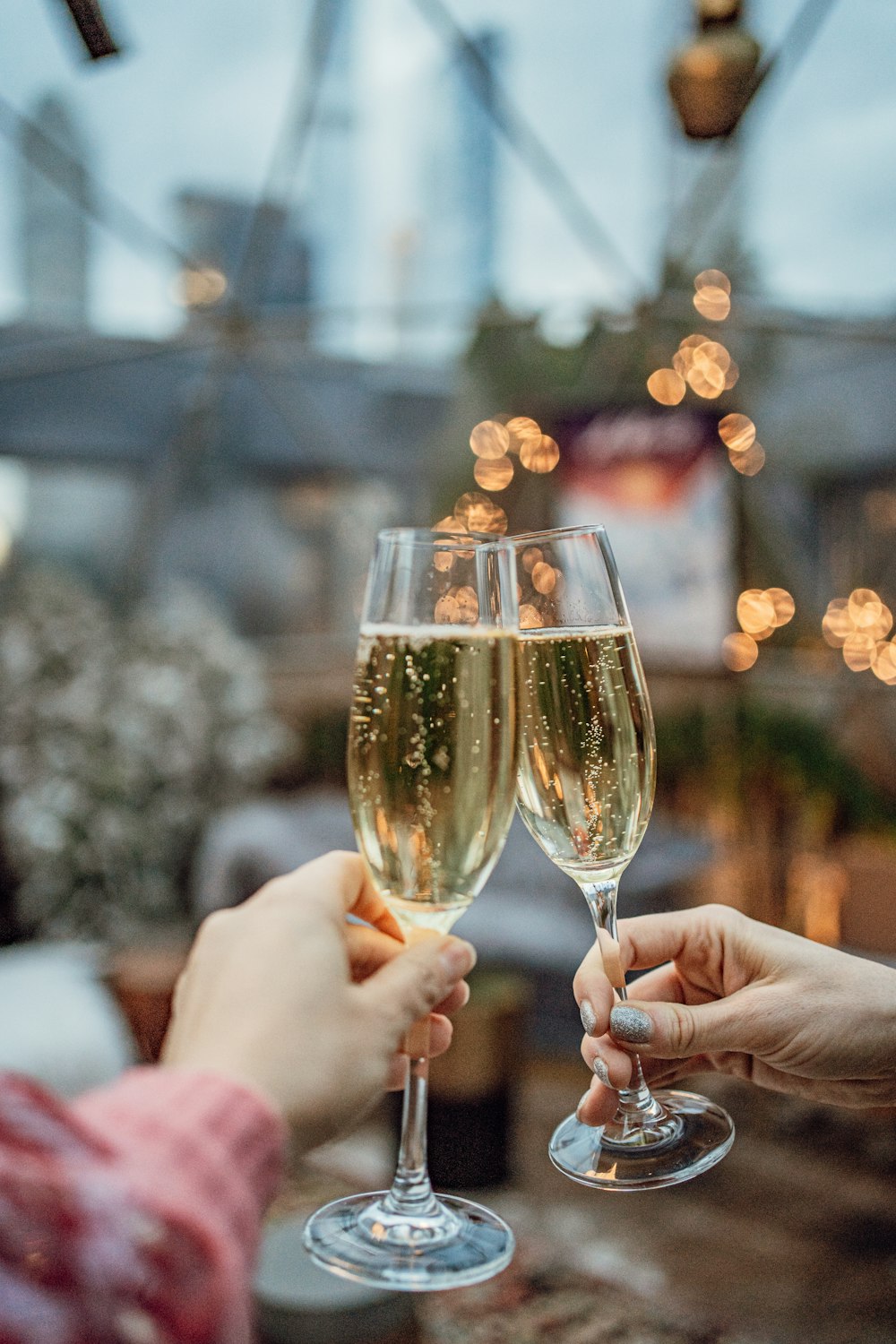 a couple of people that are holding wine glasses