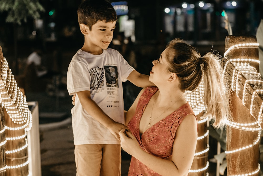 a woman and a boy standing next to each other