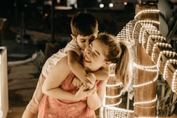 a boy and a girl hugging each other