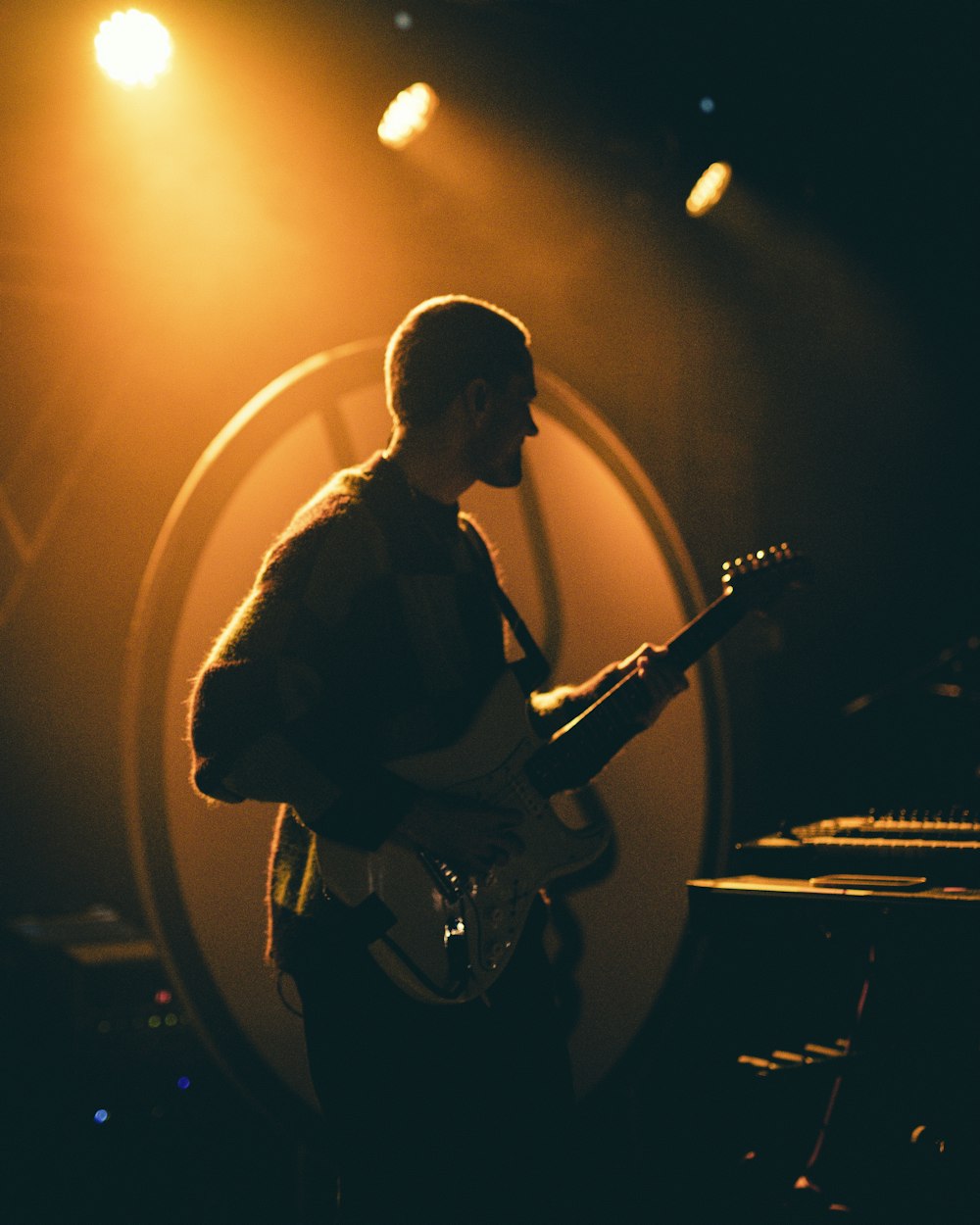 a man playing a guitar on a stage