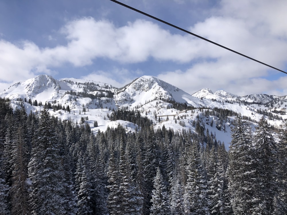 a ski lift going up a snowy mountain