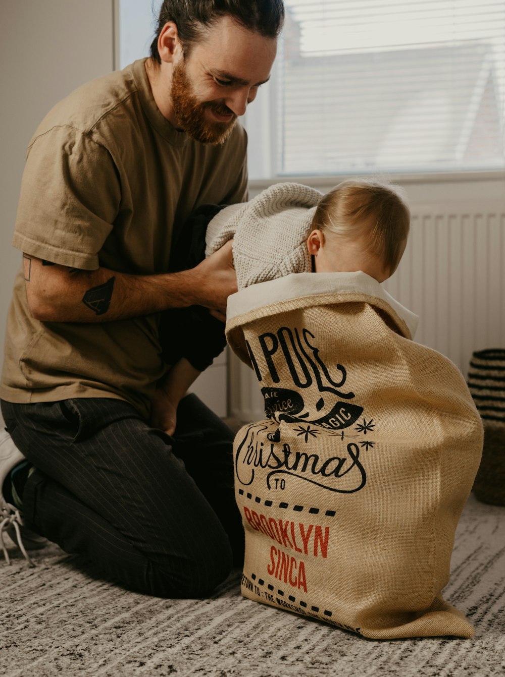 a man holding a baby in a bag