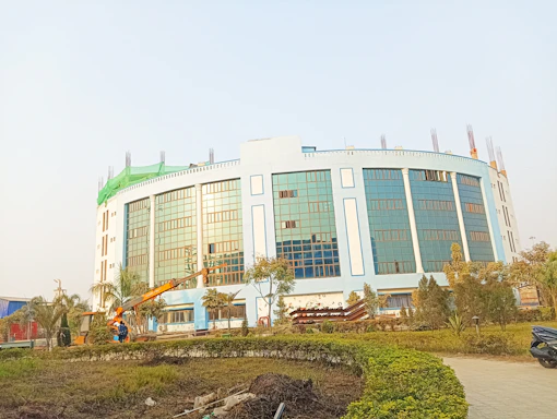 Modern office building exterior with construction and renovation tools displayed in front.