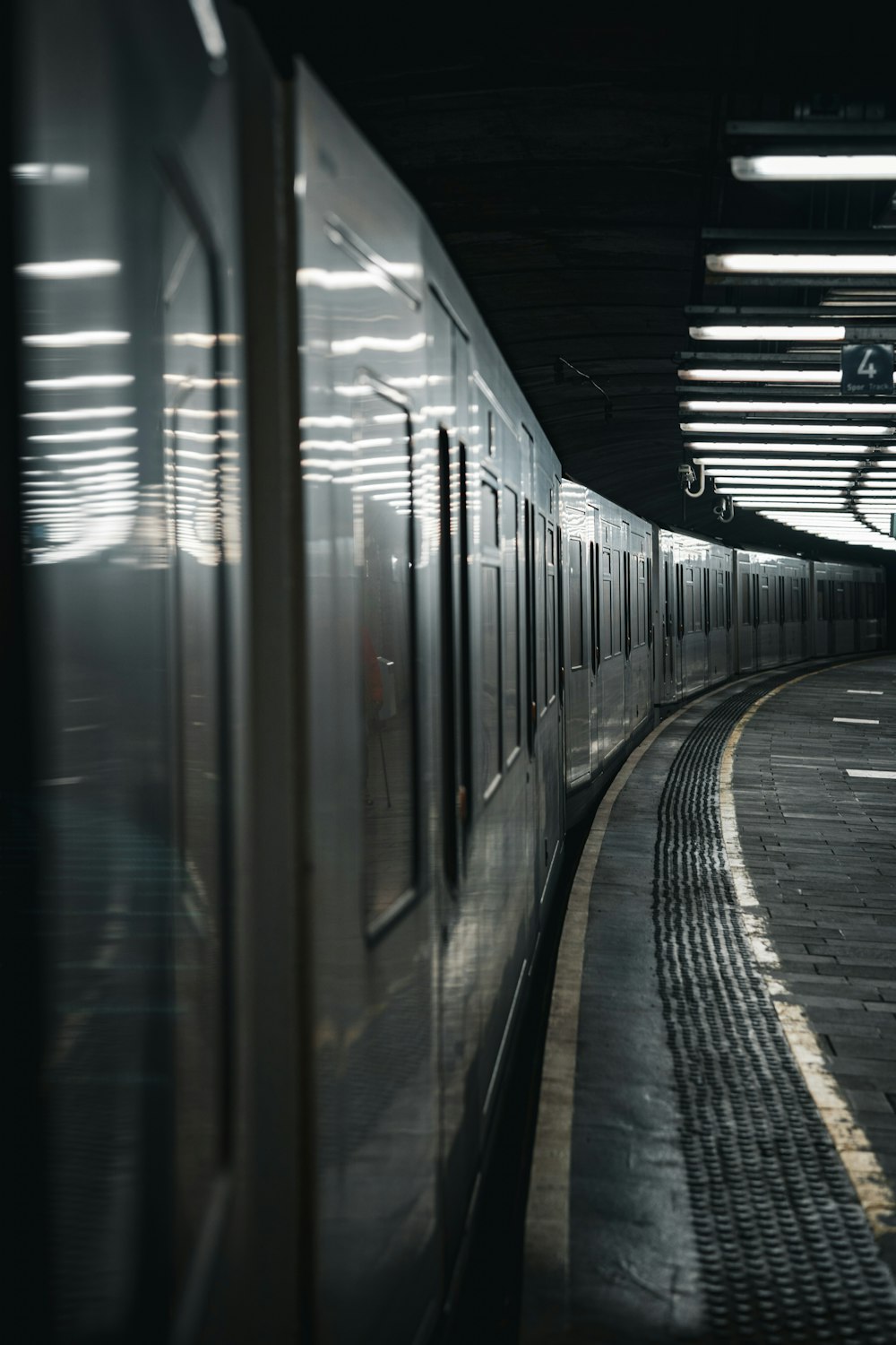 a train traveling through a train station next to a platform